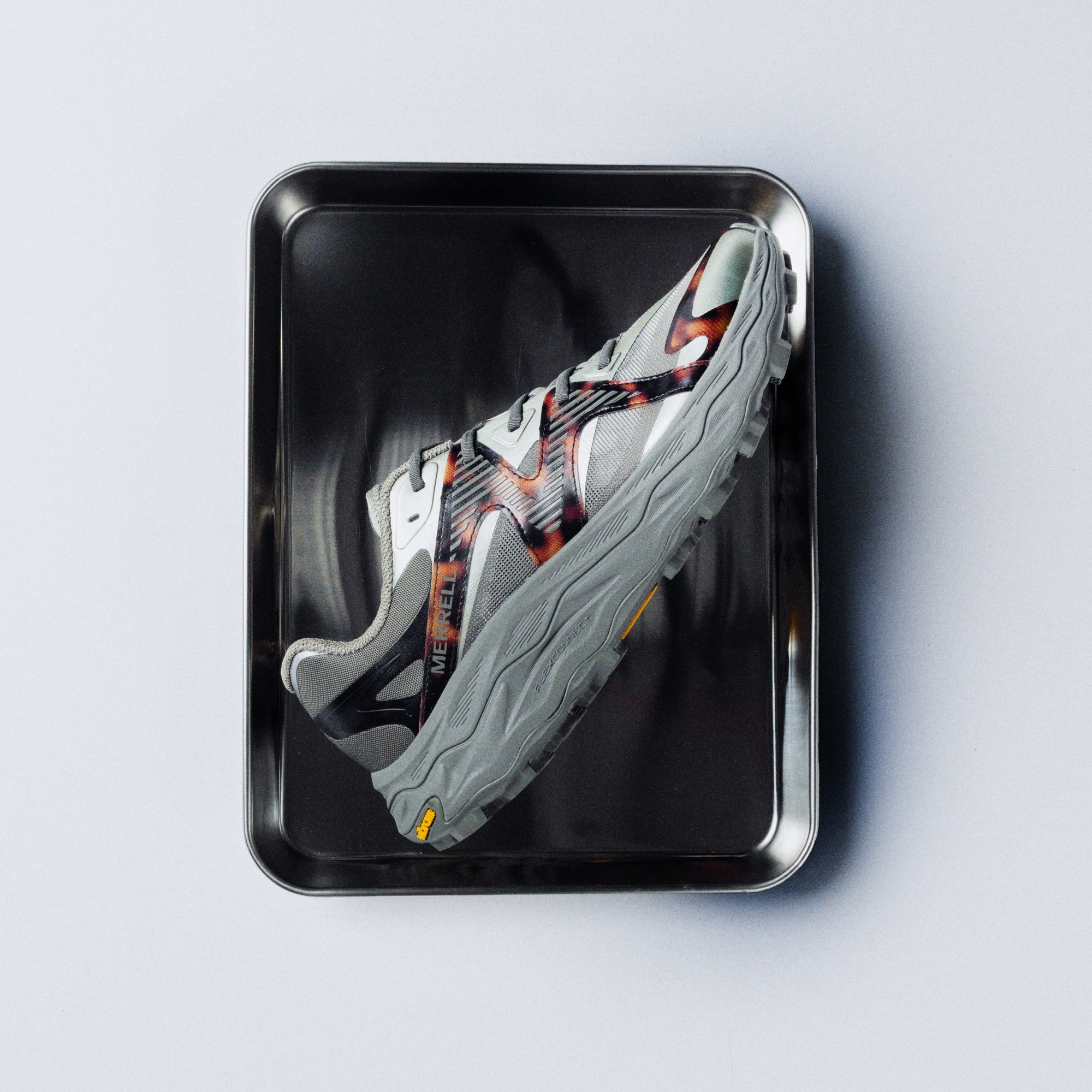 Merrell 1TRL Agility Peak 6 RPT shoe displayed on a metal tray.